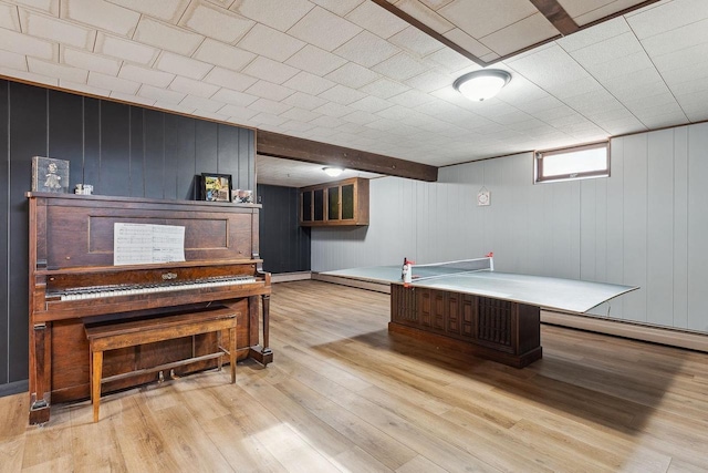 game room featuring a baseboard heating unit and light hardwood / wood-style flooring