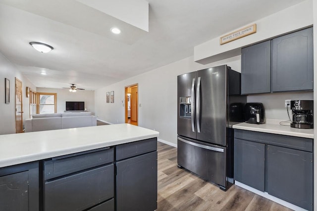 kitchen featuring gray cabinetry, hardwood / wood-style flooring, ceiling fan, and stainless steel refrigerator with ice dispenser