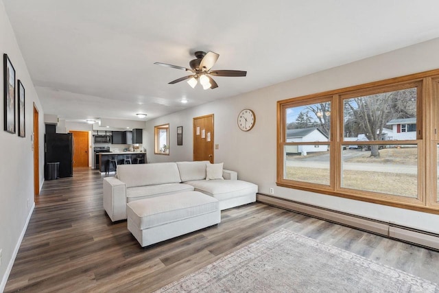 living room with a baseboard radiator, dark wood-type flooring, and ceiling fan