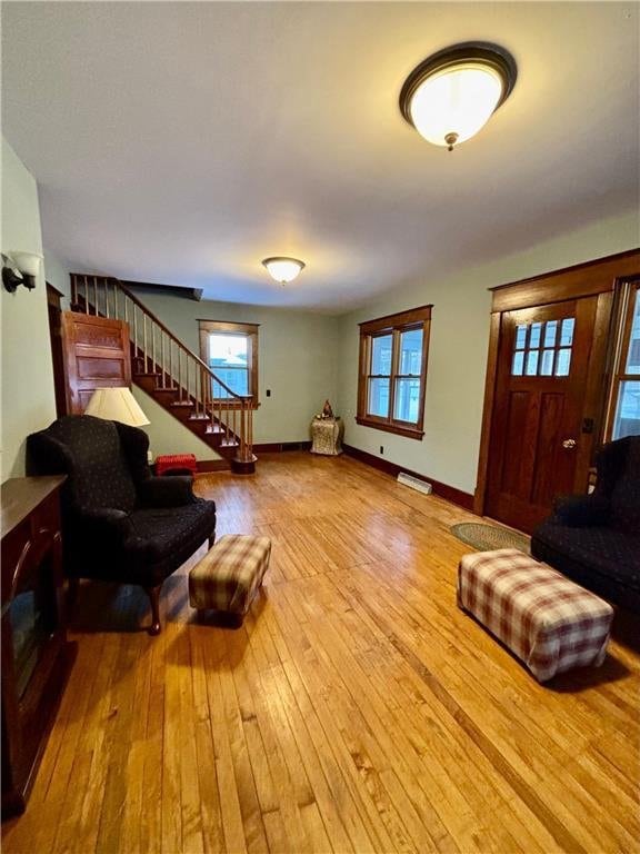 living room featuring plenty of natural light and light hardwood / wood-style flooring