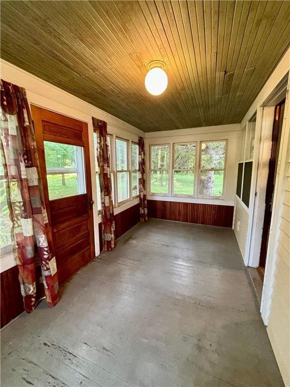 unfurnished sunroom featuring wooden ceiling