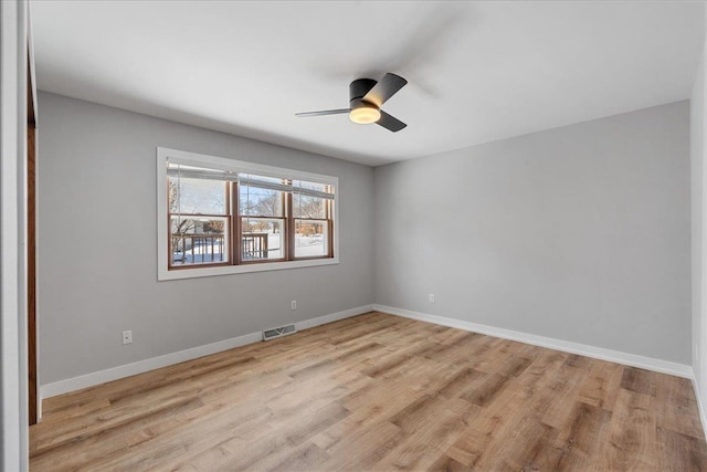 spare room with ceiling fan and light wood-type flooring