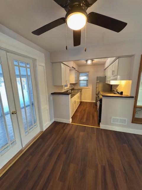 kitchen featuring white cabinetry, dark wood-type flooring, sink, and ceiling fan