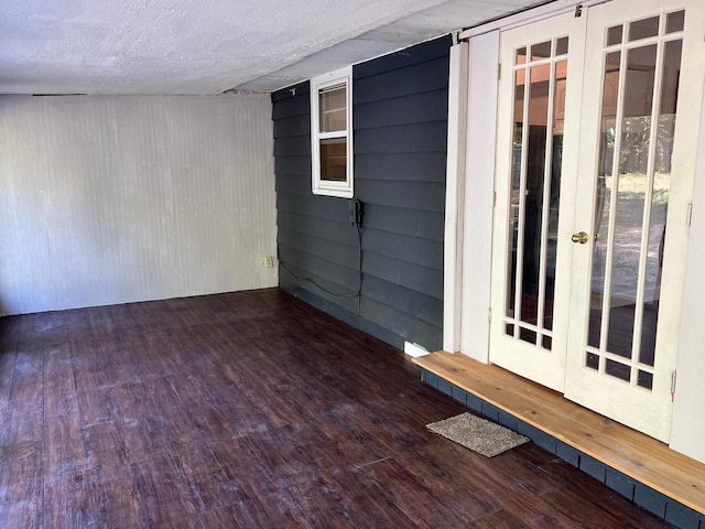 interior space featuring dark wood-type flooring and a textured ceiling