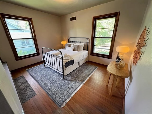 bedroom with dark wood-type flooring