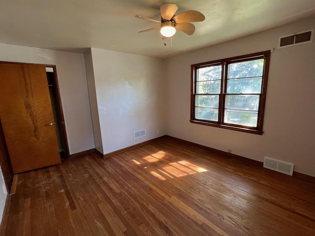 unfurnished bedroom with dark hardwood / wood-style floors and ceiling fan