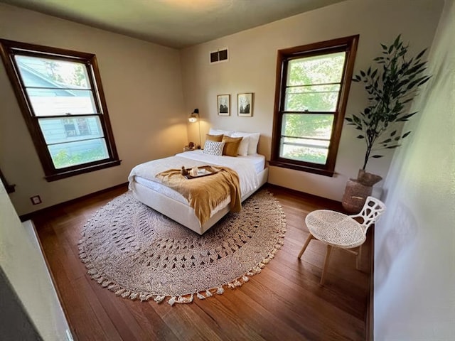 bedroom with dark hardwood / wood-style flooring