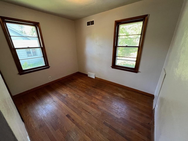 spare room featuring dark wood-type flooring