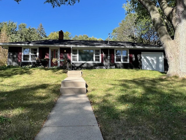 ranch-style home with a garage and a front lawn