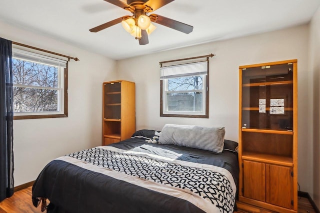 bedroom featuring wood-type flooring and ceiling fan