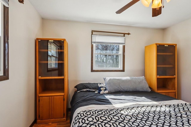 bedroom with hardwood / wood-style flooring and ceiling fan