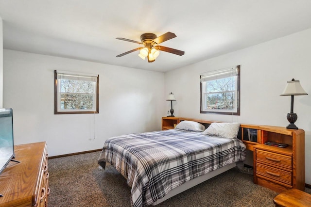 bedroom with ceiling fan and dark colored carpet