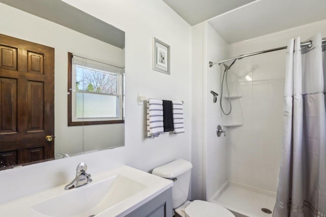 bathroom featuring walk in shower, vanity, and toilet