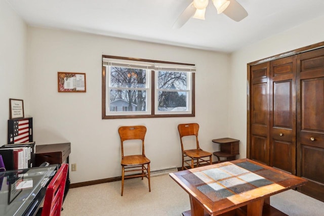 carpeted home office featuring ceiling fan