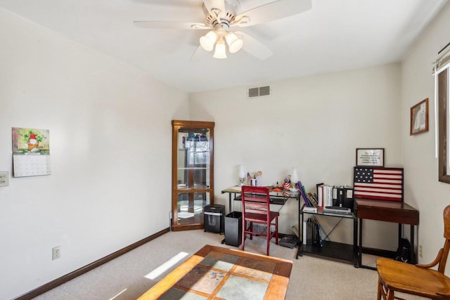 office area featuring light carpet and ceiling fan