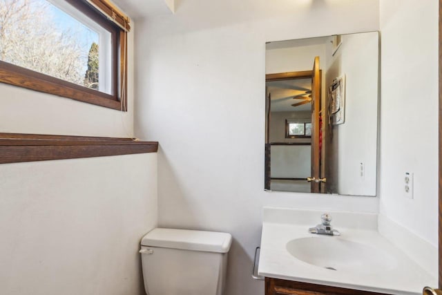 bathroom with a healthy amount of sunlight, vanity, and toilet