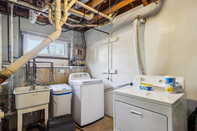 washroom with separate washer and dryer and sink