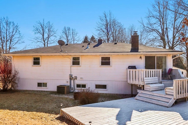 rear view of property with a wooden deck and central AC