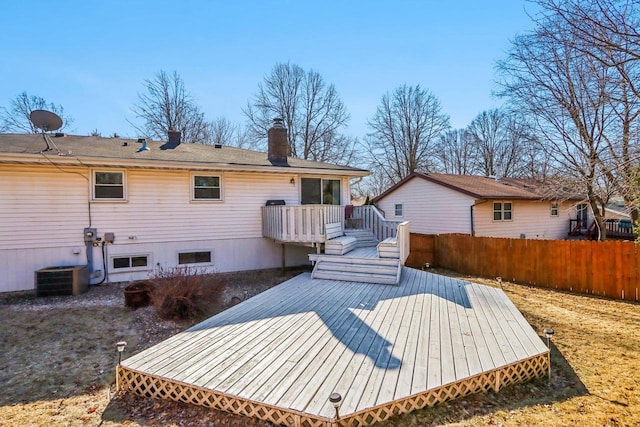 rear view of house with a deck and central air condition unit