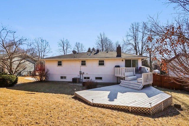 back of house featuring cooling unit, a yard, and a deck