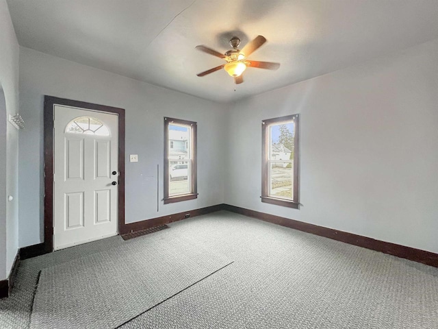 carpeted entryway with ceiling fan