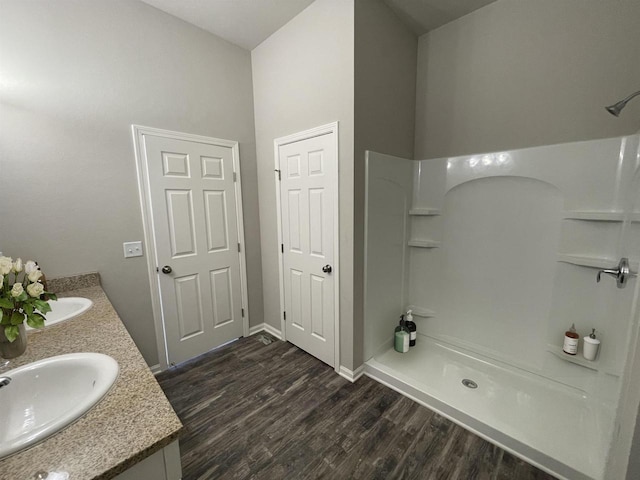 bathroom featuring vanity, hardwood / wood-style floors, and walk in shower