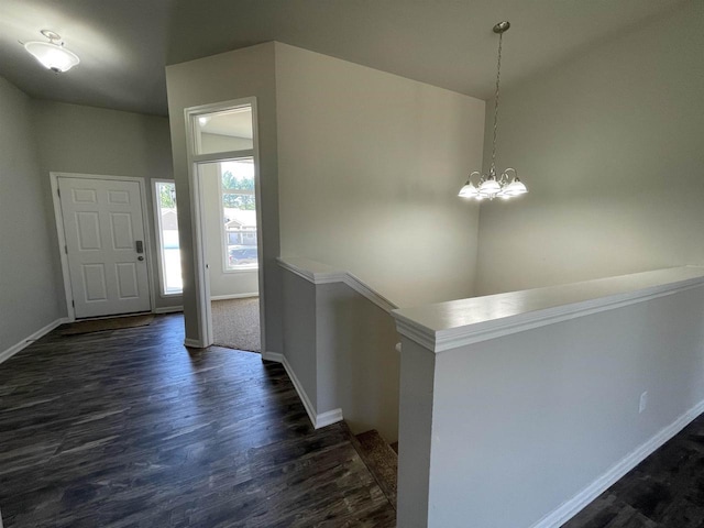 entryway with an inviting chandelier and dark hardwood / wood-style floors