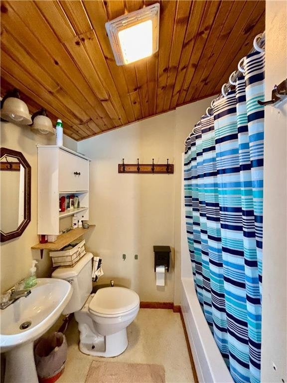 1111 N Shore Dr, Luck, WI 54853 - full bathroom featuring lofted ceiling, sink, wooden ceiling, toilet, and shower / bathtub combination with curtain