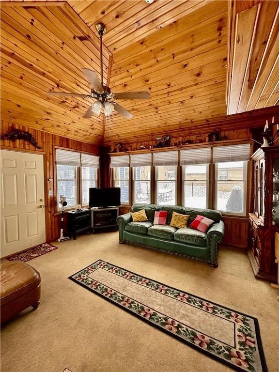 1111 N Shore Dr, Luck, WI 54853 - living room featuring lofted ceiling, wood walls, wooden ceiling, carpet floors, and ceiling fan