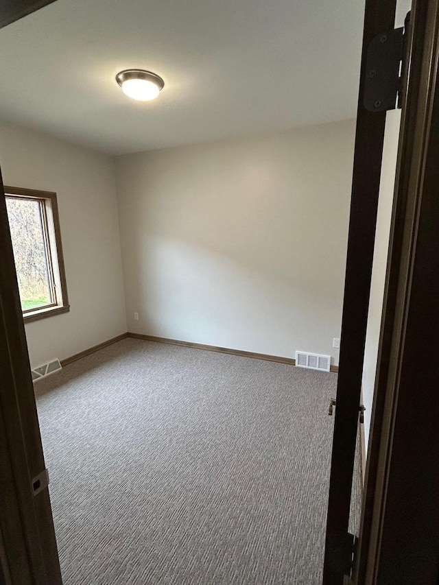 empty room featuring carpet flooring