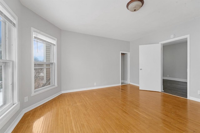 empty room with hardwood / wood-style flooring