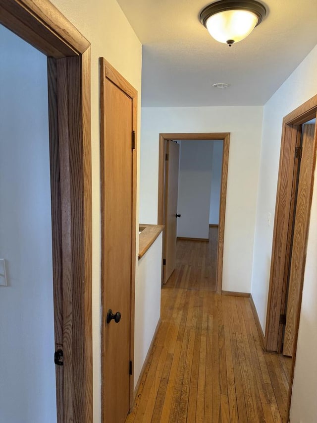 hall with light hardwood / wood-style floors