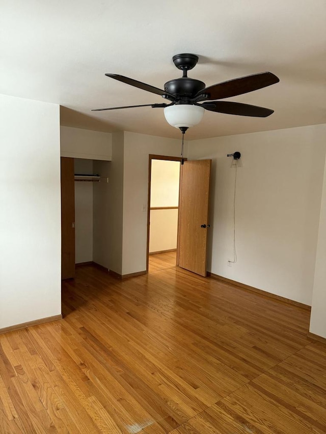 unfurnished bedroom with ceiling fan, a closet, and light hardwood / wood-style flooring