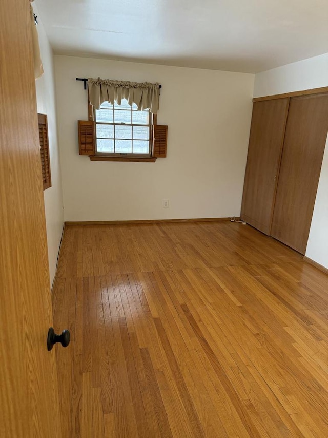 empty room with light hardwood / wood-style floors