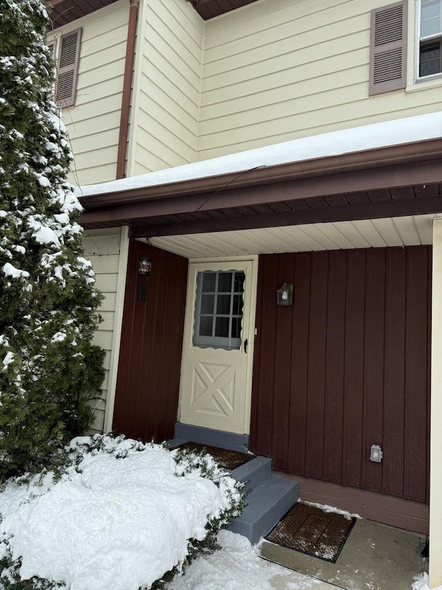 view of snow covered property entrance