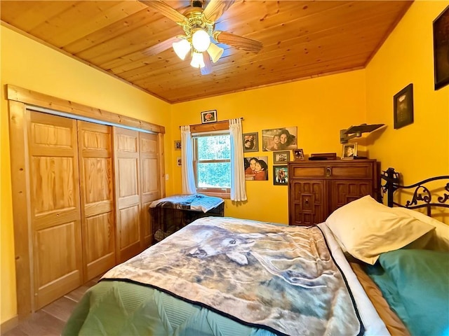 bedroom featuring ceiling fan, wood ceiling, and a closet