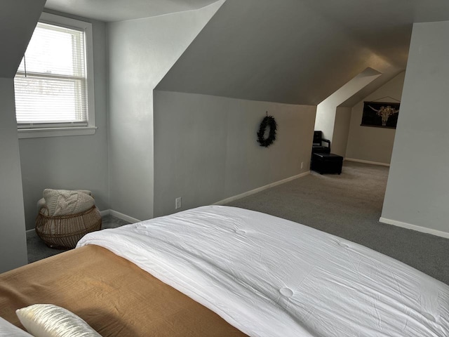 carpeted bedroom featuring lofted ceiling