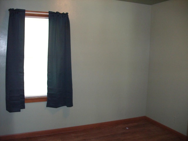 empty room featuring wood-type flooring