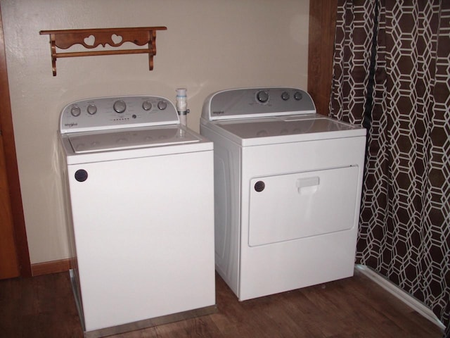 clothes washing area featuring dark hardwood / wood-style floors and independent washer and dryer