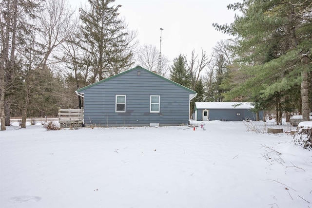 view of snow covered back of property