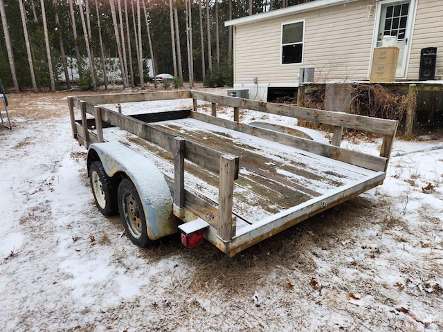 snow covered deck featuring cooling unit