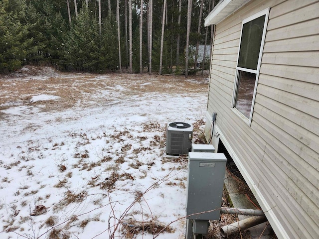 snowy yard with central air condition unit