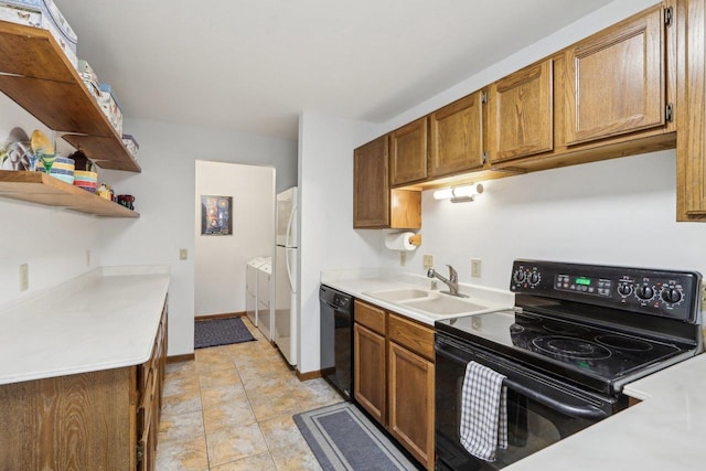 kitchen with black appliances, light countertops, a sink, and brown cabinetry