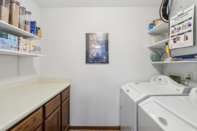 laundry room featuring baseboards and separate washer and dryer