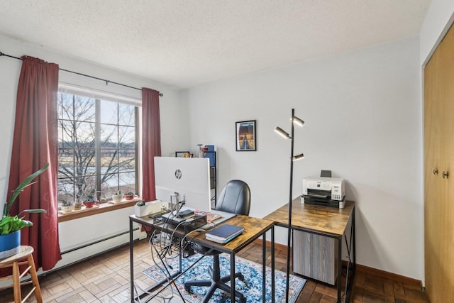 office featuring a baseboard radiator, baseboards, and a textured ceiling