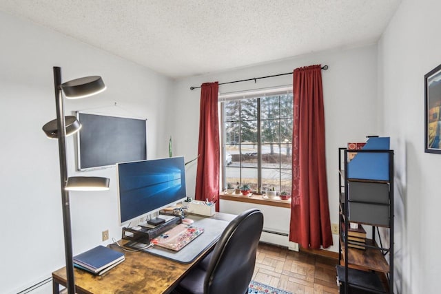 office area with a baseboard radiator and a textured ceiling