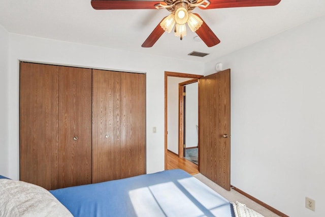 bedroom featuring a closet, visible vents, and ceiling fan