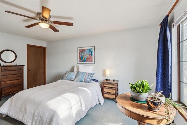 carpeted bedroom with a ceiling fan and a closet