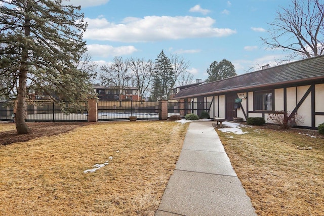 view of front of home with a front yard, fence, and stucco siding