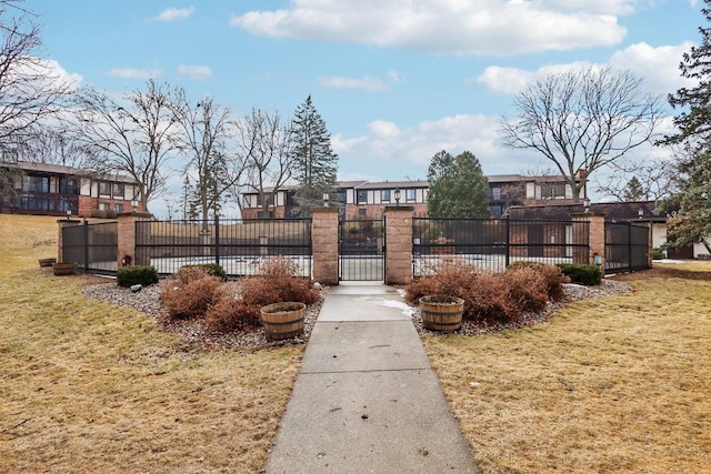 view of home's community with a residential view, a gate, fence, and a yard